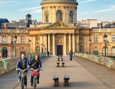 Tourist ride over a picturesque bridge, surrounded by stunning architecture.