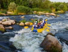 A team of adventurers paddling through rushing whitewater